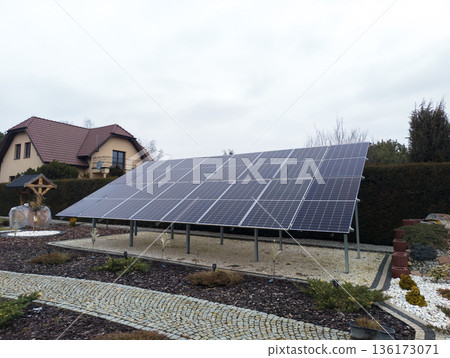 Ground mounted solar panels on landscaped residential land 136173071