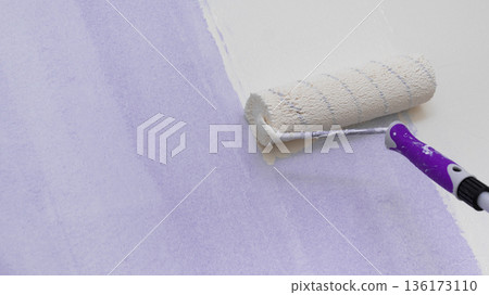 Person applying paint on wall Person applying paint on wall 136173110