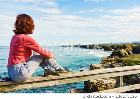 Woman visiting Cathedral Beach in Spain. Woman visiting Cathedral Beach in Spain. 136173150