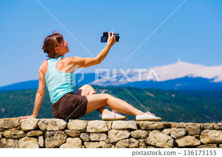 Woman take photo on mountain nature in France 136173155