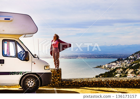 Woman enjoy caravan vacation. 136173157
