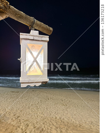 Hanging lantern on the beach at night 136173218