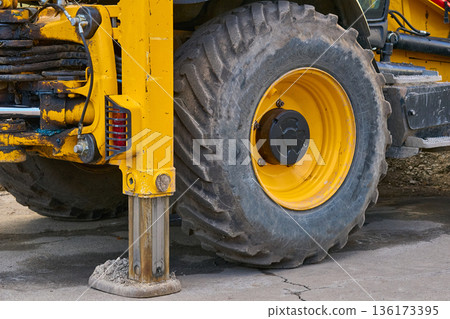 Lifting machine truck crane stands on stops,large wheel of tractor Lifting machine truck crane stands on stops,large wheel of tractor 136173395