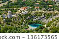 Aerial view of Cetina River source near Vrlika Croatia with turquoise karst spring village and historic church 136173565