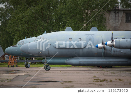 Old soviet civil propeller airliner. Russian turboprop old aircraft parking at the airport. 136173950