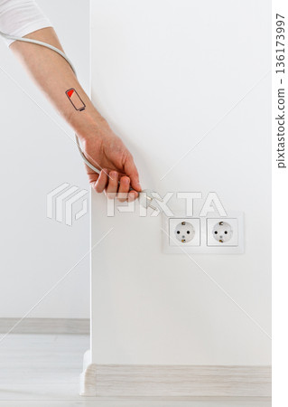 Low battery symbol drawn on person hand wrist, tiredness 136173997