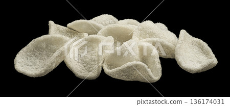 Japanese prawn crackers isolated on black background, traditional Asian restaurant snack, full depth of field 136174031