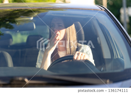Scared woman driver look in rear view mirror frightened of car accident. Stressed girl in vehicle 136174111