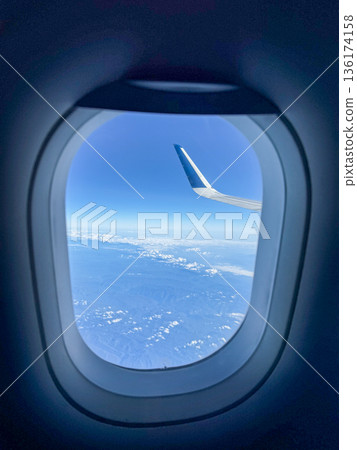Airplane Wing View Above Clouds Airplane Wing View Above Clouds 136174158