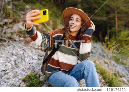 Happy tourist woman taking picture outdoors for memories. Selfie time. Lifestyle, active life. Happy tourist woman taking picture outdoors for memories. Selfie time. Lifestyle, active life. 136174251