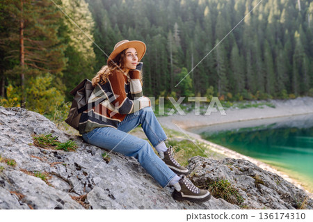 Adventure woman feeling happy among amazing mountains, forest and lake, enjoy the nature landscape 136174310