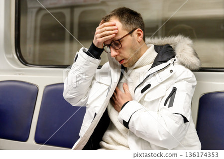 man in subway train has problems with breathing, pressure man in subway train has problems with breathing, pressure 136174353