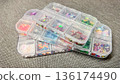 High angle view of multiple plastic organizers filled with various colorful sequins for craft DIY. 136174490