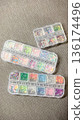 Top view of three plastic organizers with various colorful sequins and glitters for creative DIY. 136174496