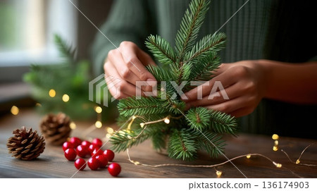 Hands crafting small pine tree decoration with lights with copy space 136174903