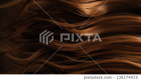 Close-up abstract texture of flowing brown hair forming elegant natural waves and curves. Organic motion, soft light and rich tones create a cinematic beauty background or luxury visual element. Close-up abstract texture of flowing brown hair forming elegant natural waves and curves. Organic motion, soft light and rich tones create a cinematic beauty background or luxury visual element. 136174919