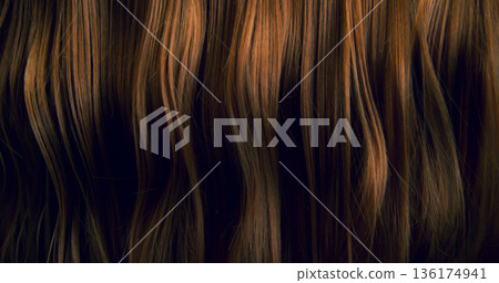 Close-up abstract texture of flowing brown hair forming elegant natural waves and curves. Organic motion, soft light and rich tones create a cinematic beauty background or luxury visual element. Close-up abstract texture of flowing brown hair forming elegant natural waves and curves. Organic motion, soft light and rich tones create a cinematic beauty background or luxury visual element. 136174941