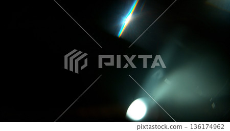Abstract cinematic lens flare with bright light burst and star rays, isolated on black background. Optical light effect ideal for VFX overlays, transitions, titles and dramatic visual accents. 136174962