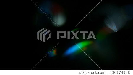 Abstract cinematic lens flare with bright light burst and star rays, isolated on black background. Optical light effect ideal for VFX overlays, transitions, titles and dramatic visual accents. 136174968