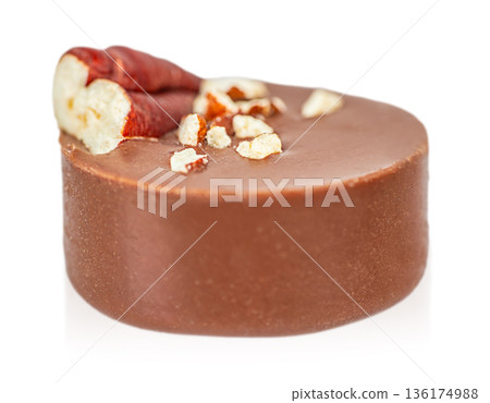 Milk chocolate candy with nut pieces isolated on white background 136174988