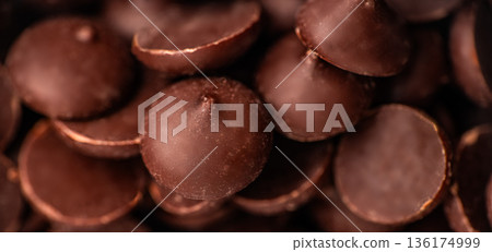 Chocolate chips background texture, baking ingredient closeup Chocolate chips background texture, baking ingredient closeup 136174999