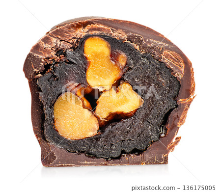 Chocolate candy cross section with whole nuts and dark filling isolated on white 136175005