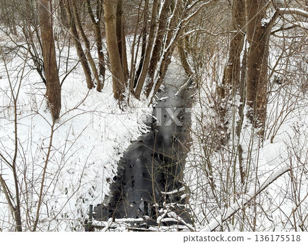 Frozen season forest stream between bare trees. Frozen season forest stream between bare trees. 136175518
