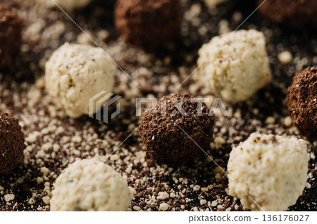 Close up of coconut and cocoa truffles on black background Close up of coconut and cocoa truffles on black background 136176027