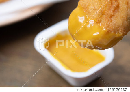 Image of chicken nuggets and mustard sauce 136176387