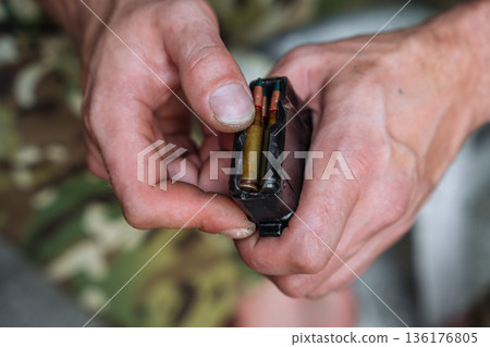 Soldier loading rifle magazine close up Soldier loading rifle magazine close up 136176805