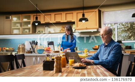 Aged wife and husband arguing with visible frustration and rage, troubled moment between distraught couple dealing with conflict, unhappiness and relationship difficulties in retirement. Camera A. Aged wife and husband arguing with visible frustration and rage, troubled moment between distraught couple dealing with conflict, unhappiness and relationship difficulties in retirement. Camera A. 136176970