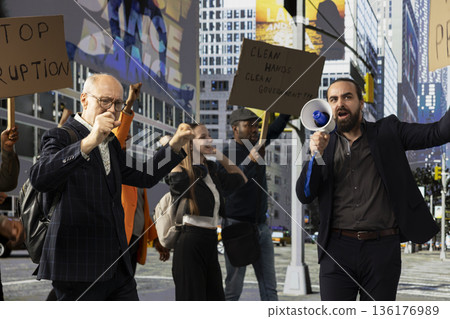 Protesters gather in rally against corrupted government and scandalous politics, holding cardboard posters and banners with angry warning messages focused on democracy and anti-corruption. Protesters gather in rally against corrupted government and scandalous politics, holding cardboard posters and banners with angry warning messages focused on democracy and anti-corruption. 136176989