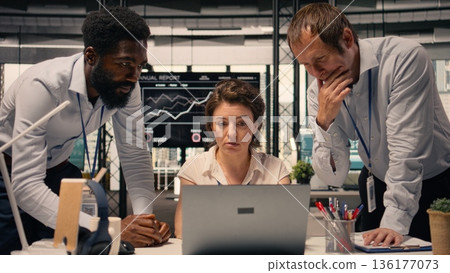 Business collaboration scene, diverse professionals, working together on laptop, data analysis, KPI metrics, modern corporate workspace. Risk assessment, corporate lifestyle, goals. Business collaboration scene, diverse professionals, working together on laptop, data analysis, KPI metrics, modern corporate workspace. Risk assessment, corporate lifestyle, goals. 136177073