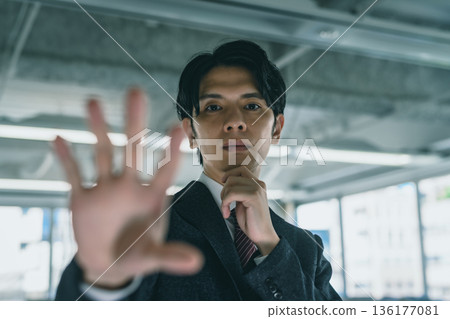 A man holds his hand 136177081