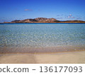 The breathtaking sea of Stintino near Olbia, Sardinia, reveals crystal-clear turquoise waters gently washing over fine white sand. Bathed in warm Mediterranean sunlight, this peaceful coastal 136177093