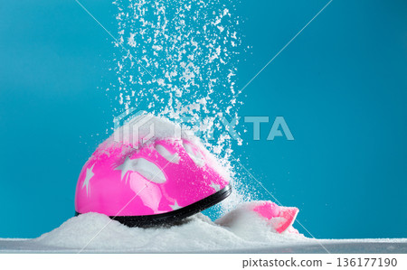 Pink safety helmet gear was covered with snow winter. Snow winter make bicycle slippery road so Safety helmet gear help protective children from danger. Blue Sky background isolated Pink safety helmet gear was covered with snow winter. Snow winter make bicycle slippery road so Safety helmet gear help protective children from danger. Blue Sky background isolated 136177190