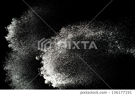 Fluffy White snow splash flying or throwing in mid air. Snowfall on Black background isolated. Snow dust element falling over dark night 136177191