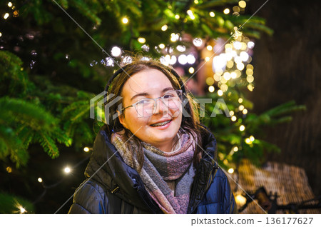 Cheerful Christmas Girl with Festive Lights Cheerful Christmas Girl with Festive Lights 136177627