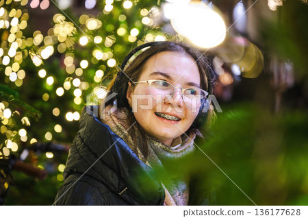 Cheerful Christmas Girl with Festive Lights Cheerful Christmas Girl with Festive Lights 136177628