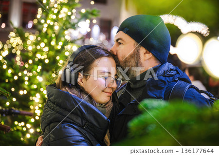 Cheerful Christmas Girl with Her Father and Festive Lights 136177644