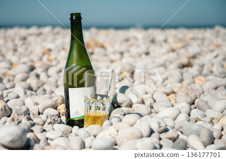 Bottle and glass of cider on Etretat beach Bottle and glass of cider on Etretat beach 136177701