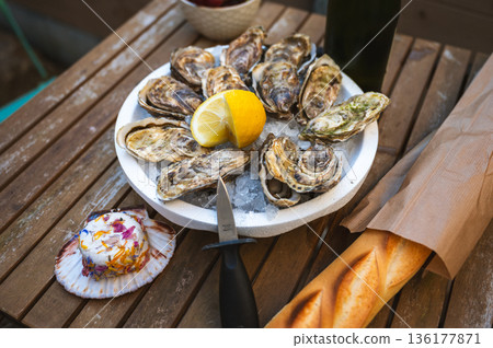Fresh Raw Oysters with Citron, Baguette, Butter, and Cider 136177871