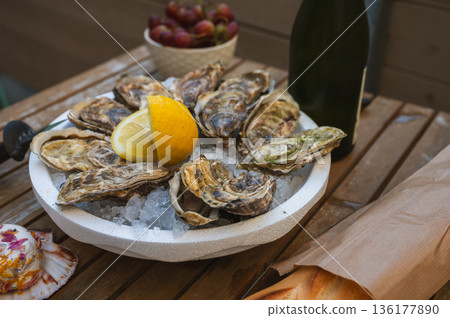 Fresh Raw Oysters with Citron, Baguette, Butter, and Cider 136177890