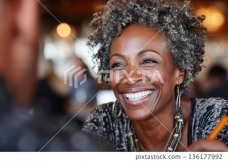 Woman with gray curls smiling at conversation Woman with gray curls smiling at conversation 136177992