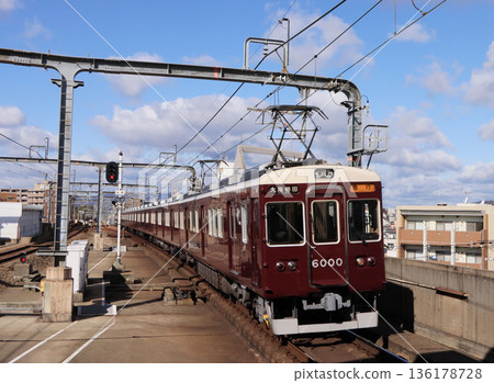Hankyu Takarazuka Line 6000 series express train arriving at Toyonaka Station 136178728