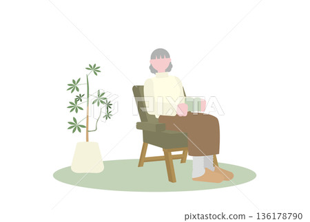 Senior woman reading on a single sofa Senior woman reading on a single sofa 136178790