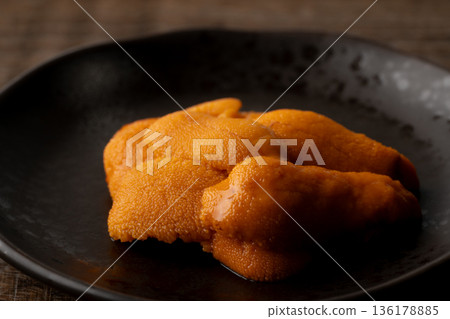Close-up of raw sea urchin on a plate 136178885