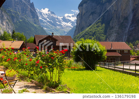 Lauterbrunnen valley with alpine village and cliffs in summer Lauterbrunnen valley with alpine village and cliffs in summer 136179198