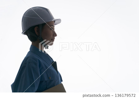 Silhouette of a woman in work clothes Silhouette of a woman in work clothes 136179572