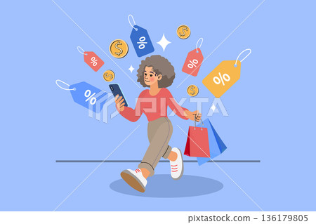 A happy woman walking while holding shopping bags and using a smartphone. Illustration featuring floating discount price tags and gold coins on a blue background, representing online shopping, sales 136179805